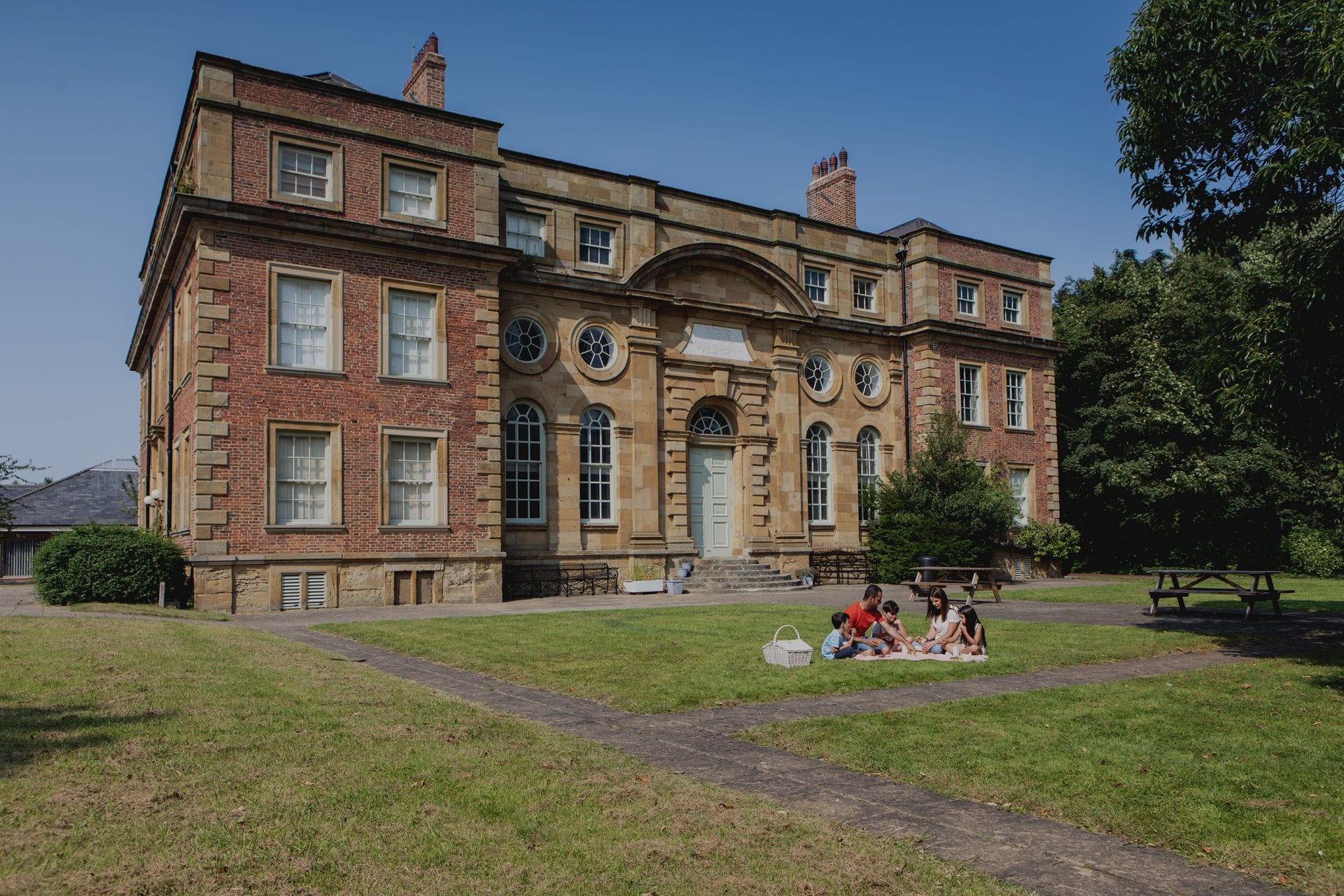 A family has a picnic in the grounds of Kirkleatham Museum