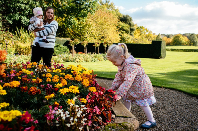 A young family enjoying the scent of the flowers at Ormesby Hall