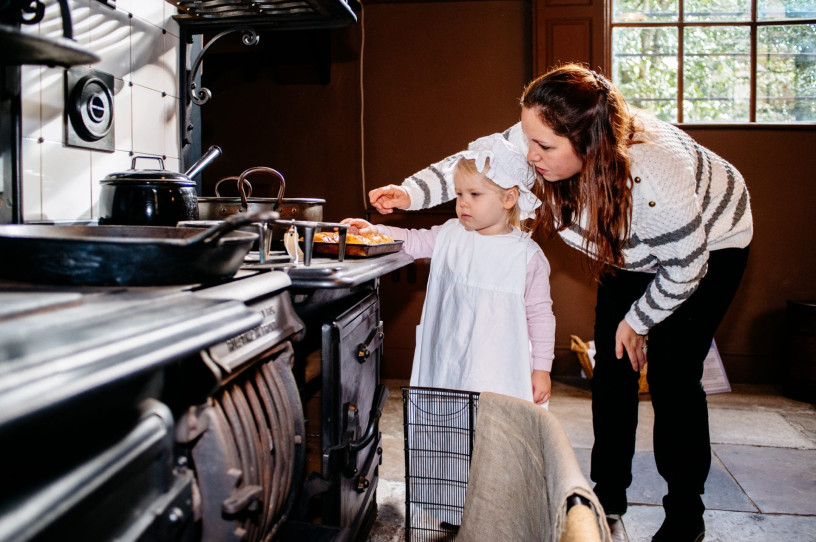 A mum and daughter explore the kitchen at Ormesby Hall