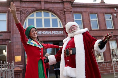 Santa and elf outside Dorman Museum