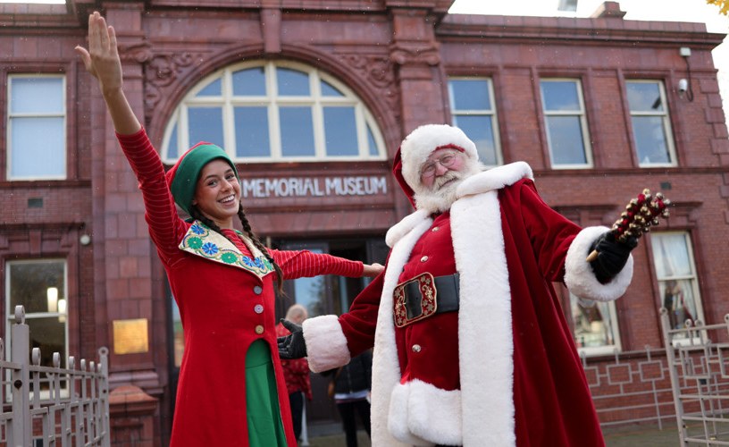 Santa and elf outside Dorman Museum