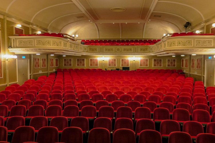 Empty red seats in a theatre