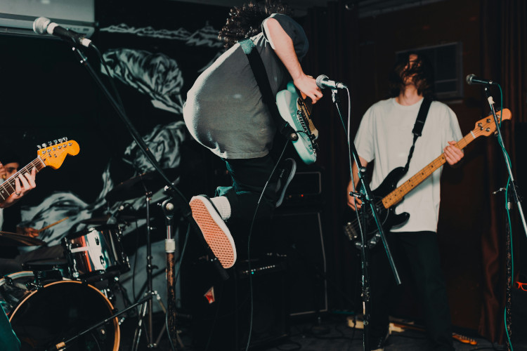 Guitarist jumping on stage