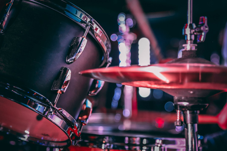 Black acoustic drum set with shiny hi hat