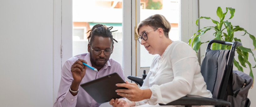 a businesswoman in a wheelchair with a disability looking at the laptop Mobile