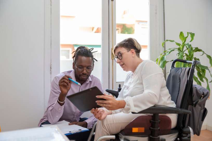 a businesswoman in a wheelchair with a disability looking at the laptop